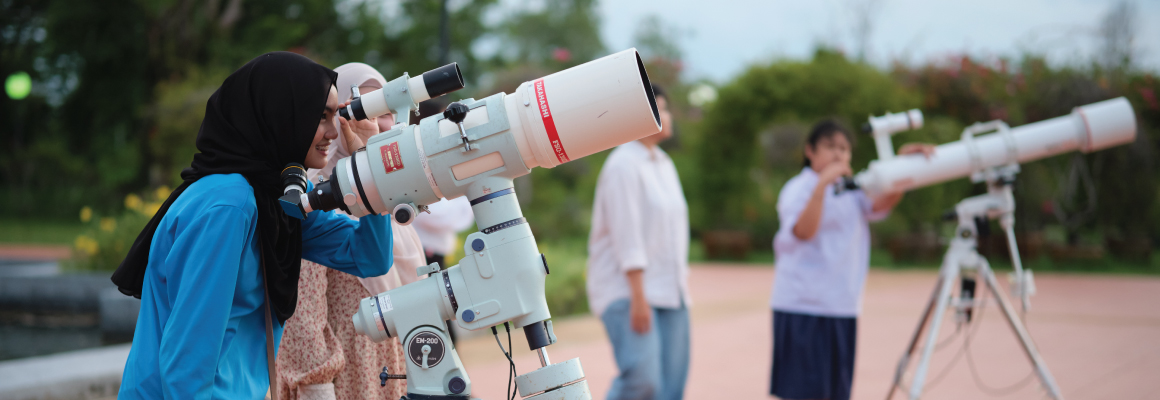 People looking through telescopes