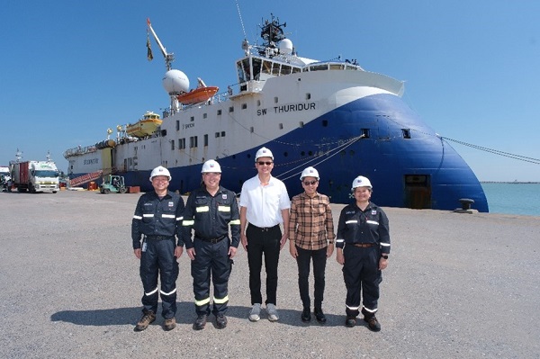 people standing in front of a marine vessel